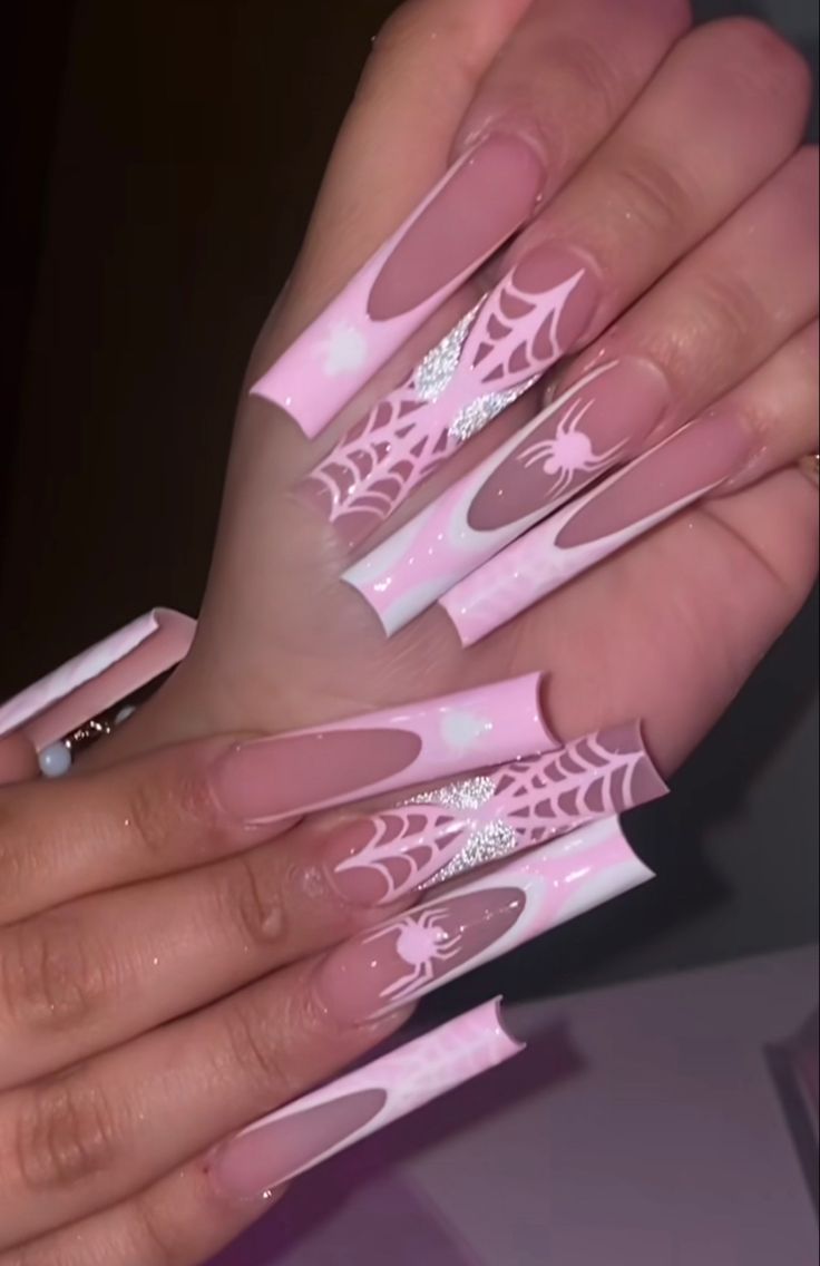 a woman's hands with pink and white nail designs