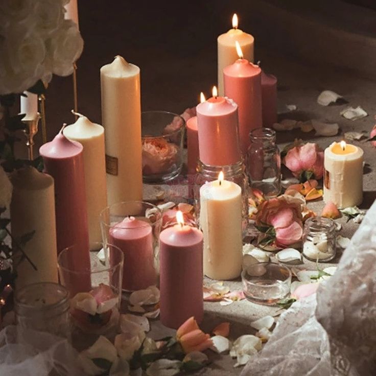 a table topped with lots of candles and flowers