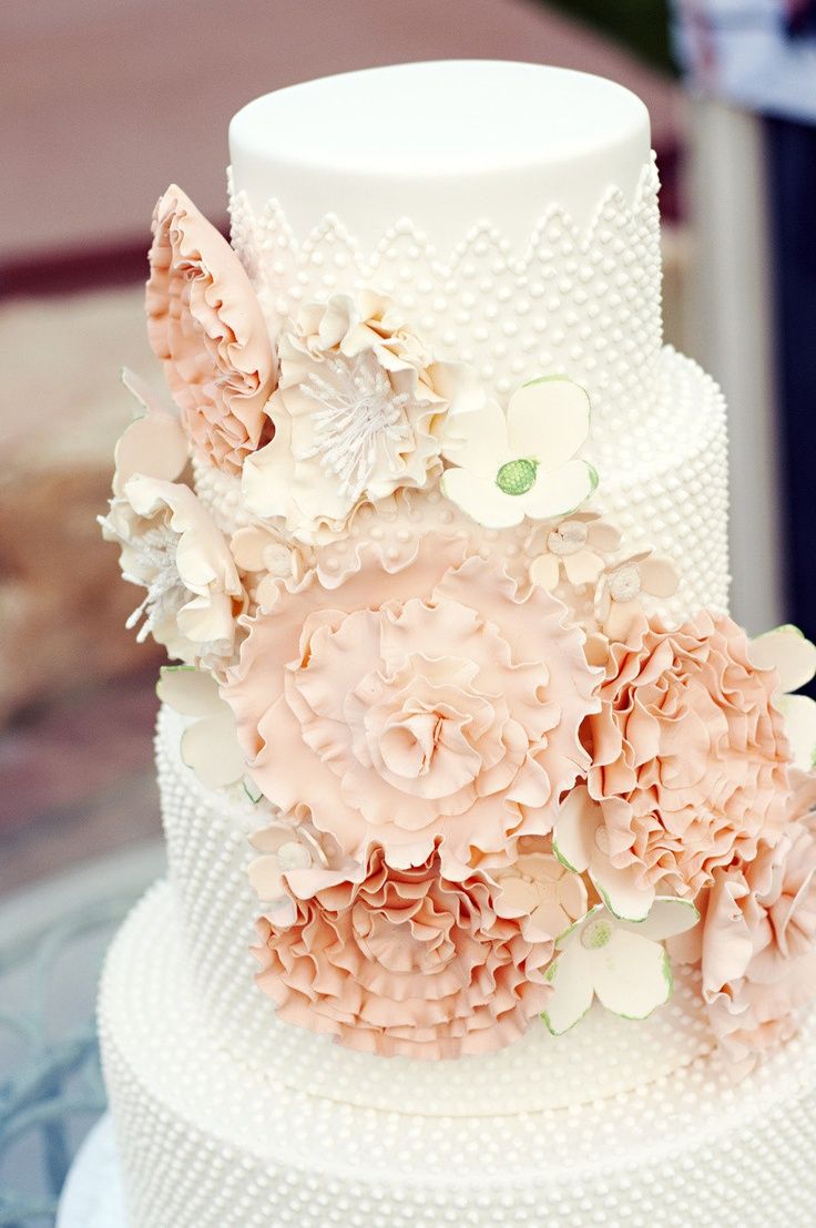 a three tiered cake with flowers on it