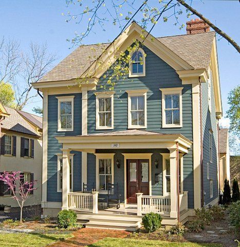 a two story house with blue siding and white trim