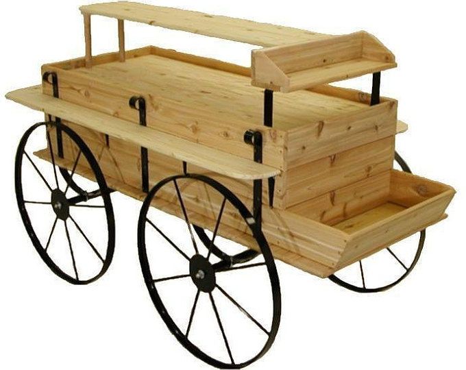 an old fashioned wooden wagon with wheels on it's sides and two trays in the back