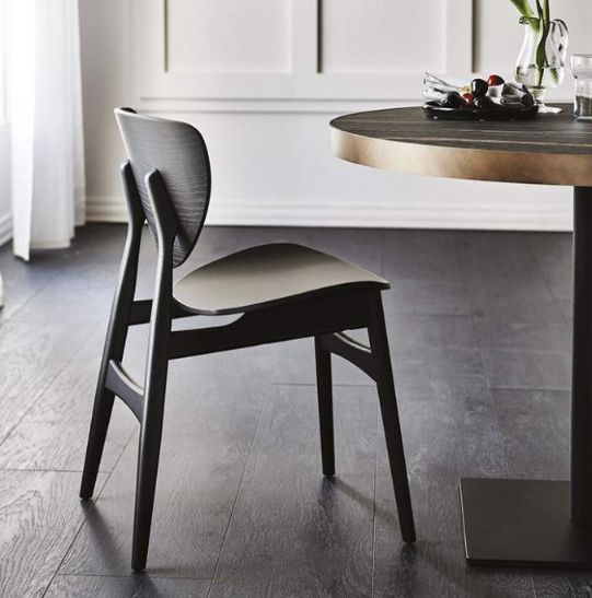 a dining room table and chair with flowers on it