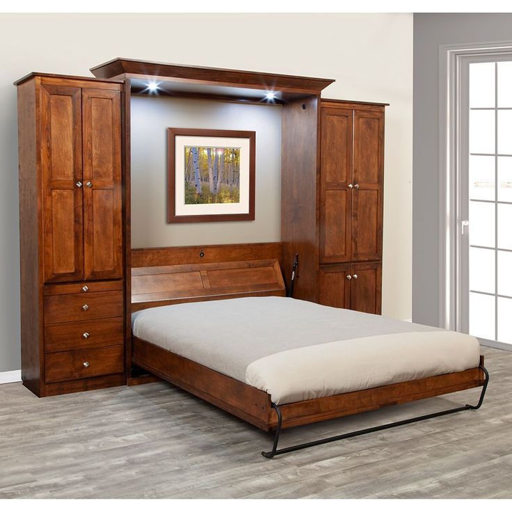 a bedroom with a bed, armoires and an open closet in the wall