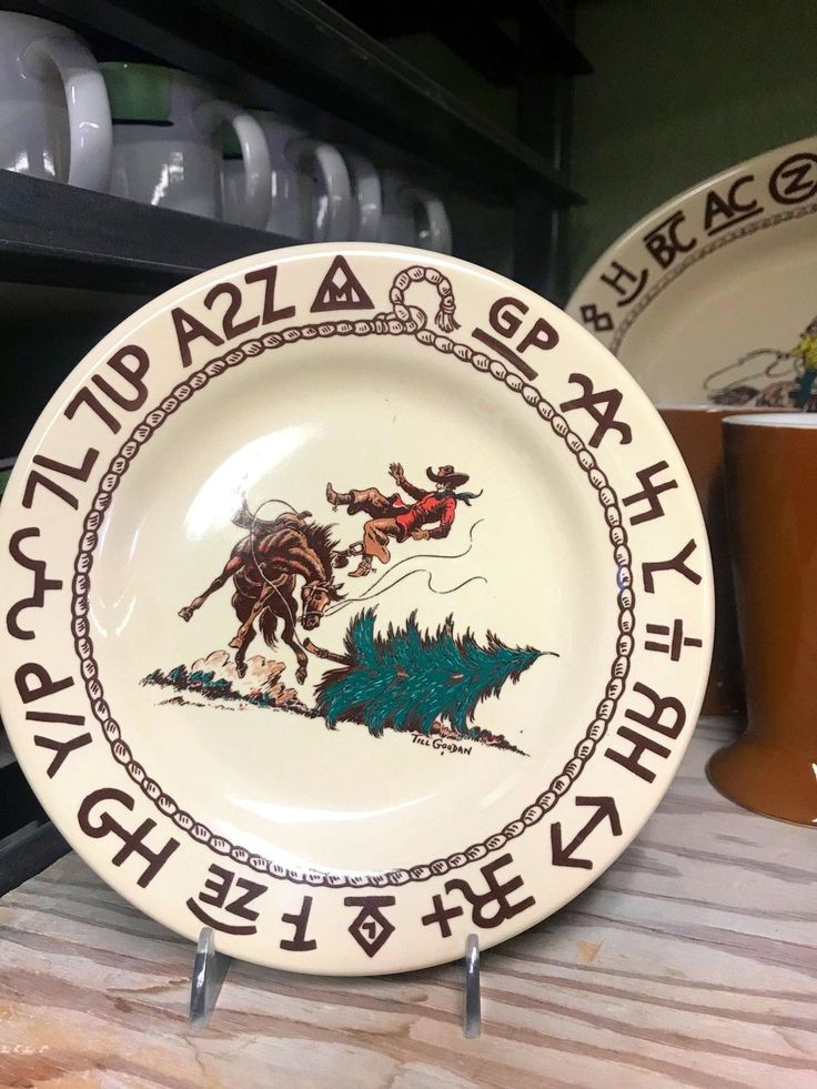 two plates with designs on them sitting on a table