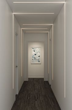 an empty hallway with a painting on the wall