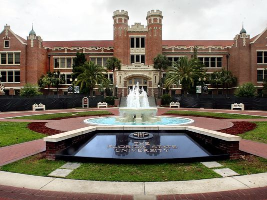 a fountain in front of a large building