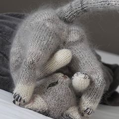 a stuffed animal laying on top of a bed