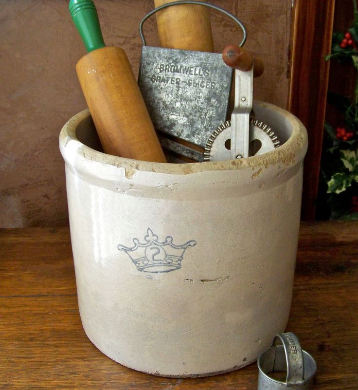 an old bucket with tools in it sitting on a table