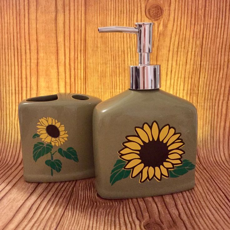 two ceramic soap dispensers with sunflowers painted on the front and back