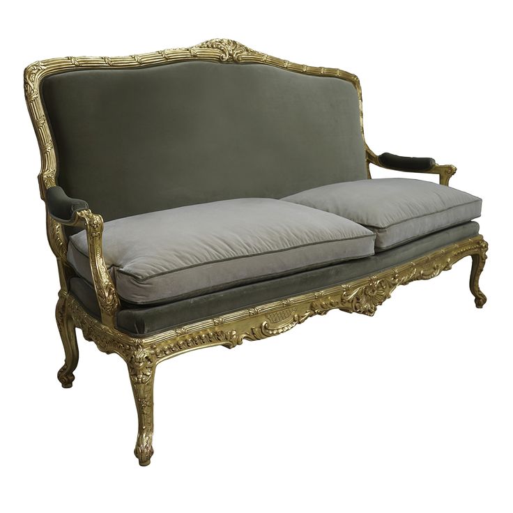 an antique couch with grey cushions and gold trim