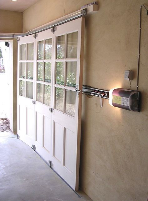 an empty room with two doors and a light on the wall above it that is lit up