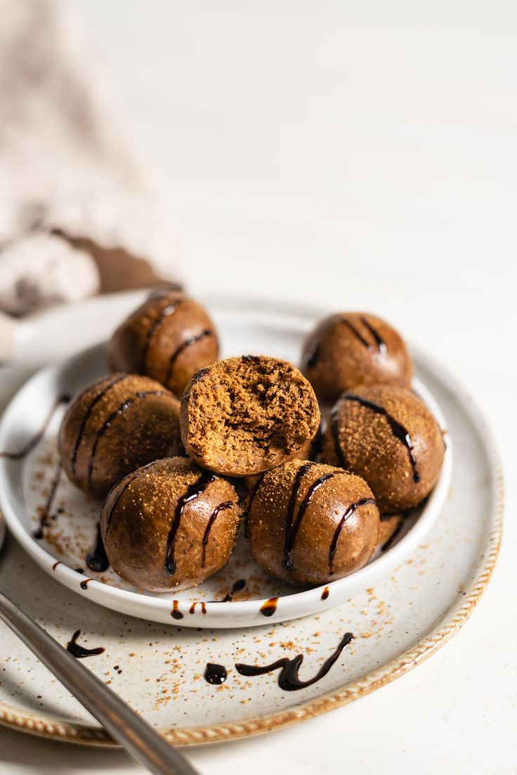 chocolate covered donuts on a plate with spoons