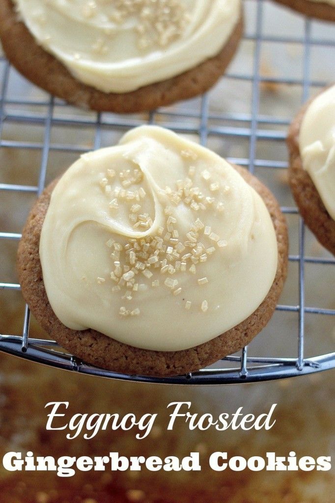 some cookies with frosting and sprinkles on a cooling rack