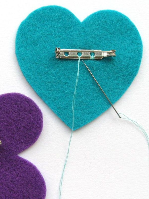 a pair of scissors next to a felt heart