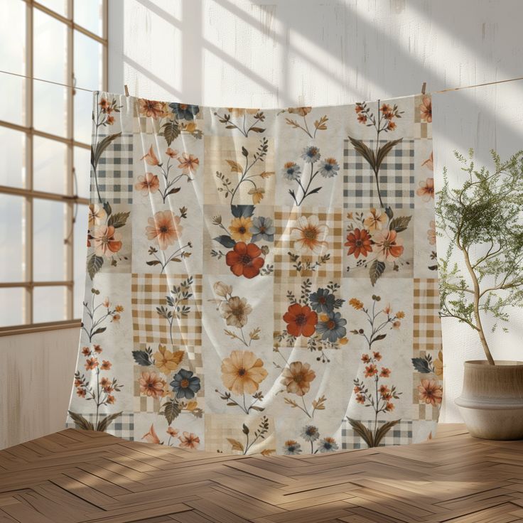 an image of a window curtain with flowers on it in front of a potted plant