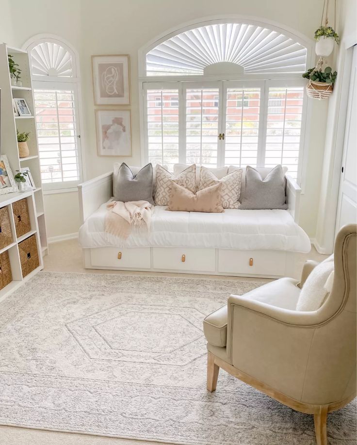 a living room filled with lots of furniture and decor on top of a white rug