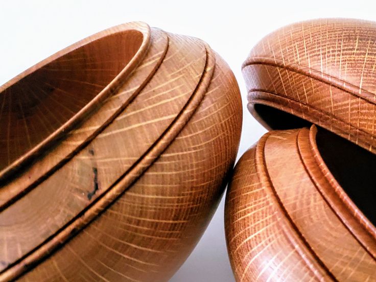 two wooden bowls sitting next to each other