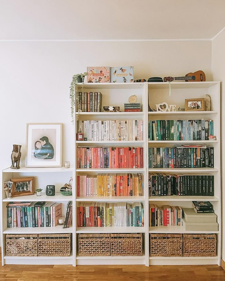 a bookshelf filled with lots of books in a room