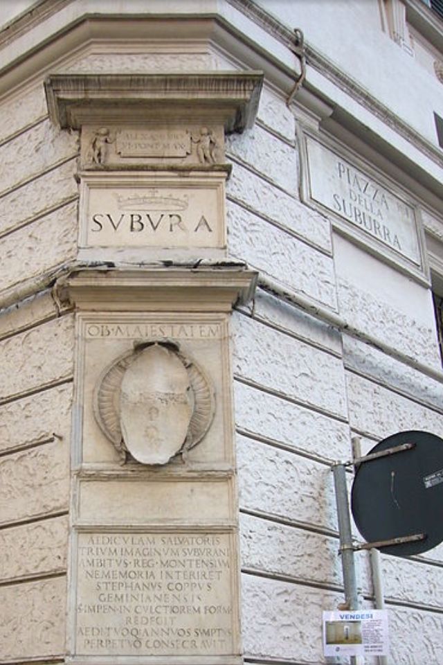 the corner of a building with a plaque on it