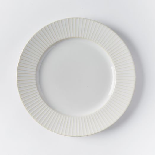 an empty white plate on a white surface