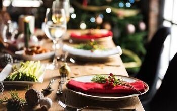 a table set for christmas dinner with plates and utensils