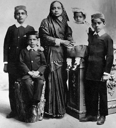 an old black and white photo of four children