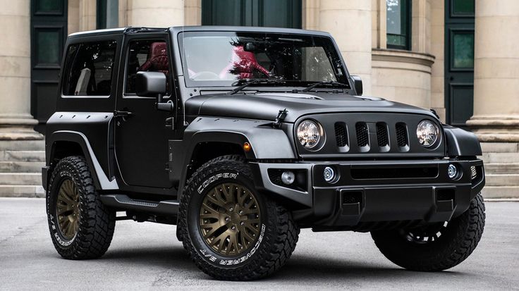 a black jeep parked in front of a building