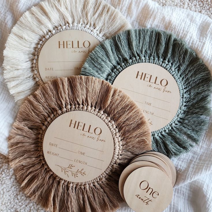 three round coasters with the words hello written on them