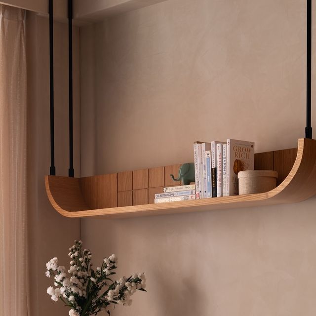 a vase filled with flowers sitting on top of a wooden shelf