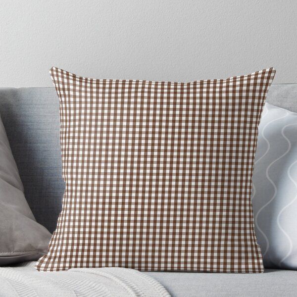 a green and white checkered pillow on a couch