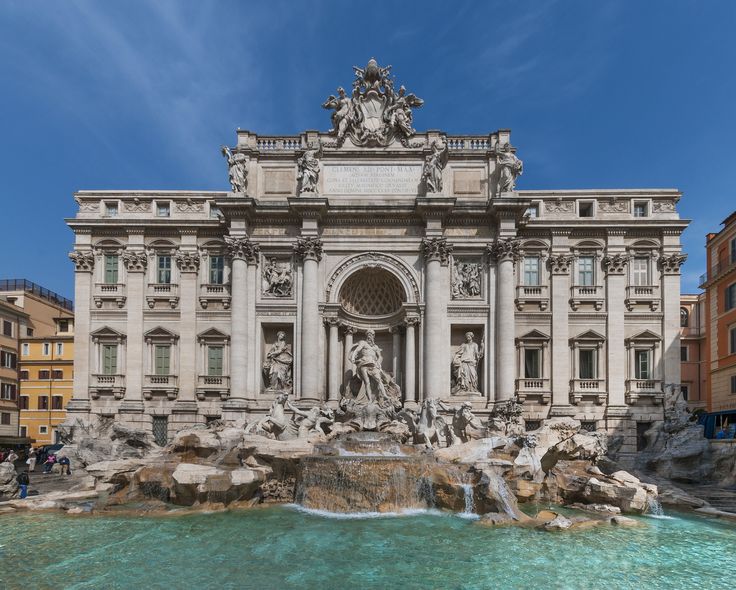 a large building with a fountain in front of it