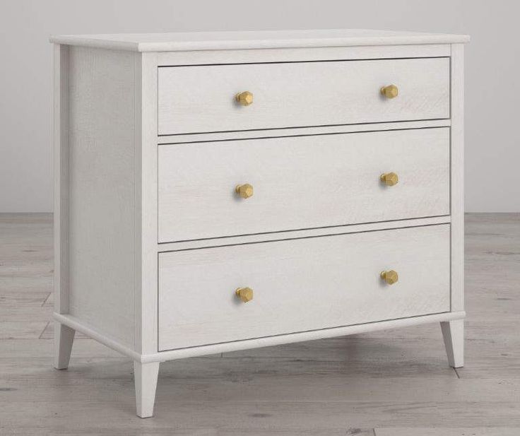 a white dresser sitting on top of a wooden floor