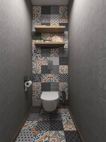 a bathroom with tiled walls and flooring next to a shelf filled with toilet paper