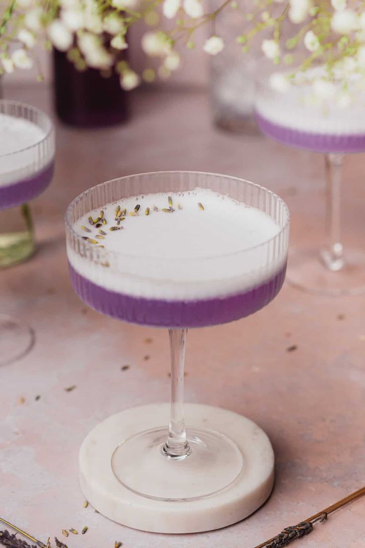 lavender gin cocktail in a coupe glass with the text lavender gin cocktail on top and below