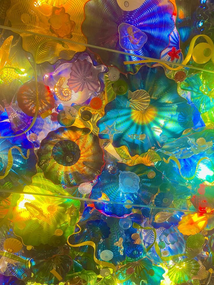 the ceiling is covered in many colorful glass objects