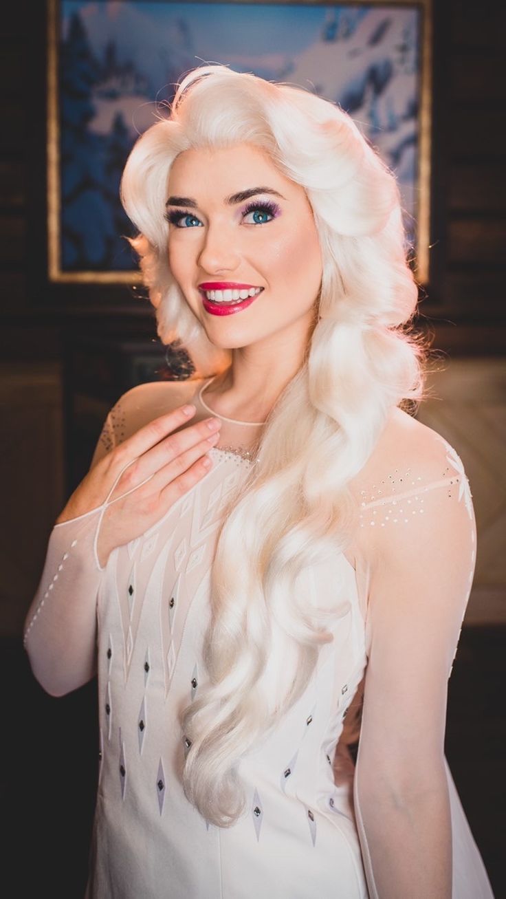 a woman with long white hair and blue eyes