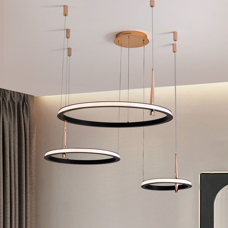 several circular lights hanging from the ceiling in a room