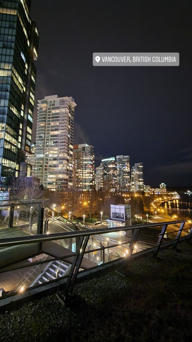 the city skyline is lit up at night