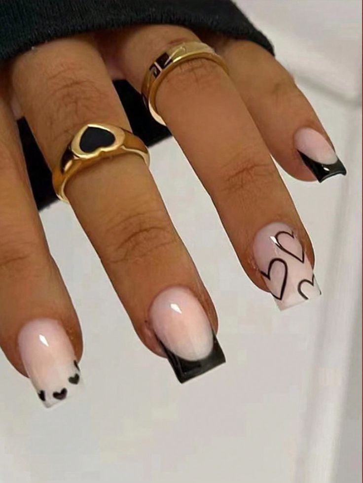 a woman's nails with black and white designs on them