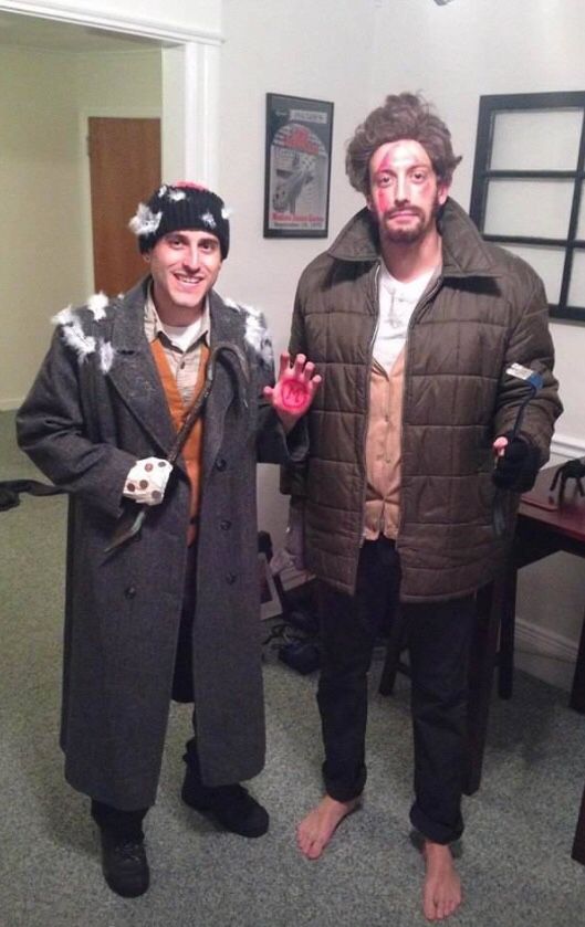 two men dressed in costumes standing next to each other