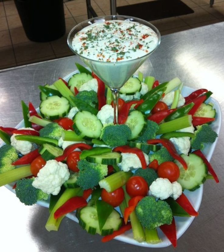 a platter filled with veggies and dip