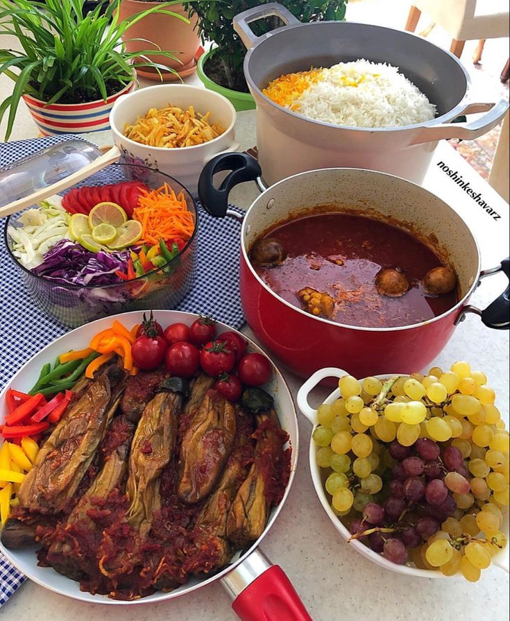 a table topped with lots of food and bowls filled with different types of foods next to each other