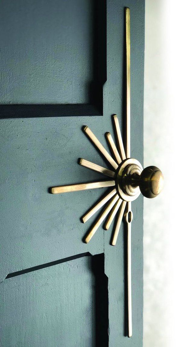 the door handle is made out of wood and has a sunburst design on it