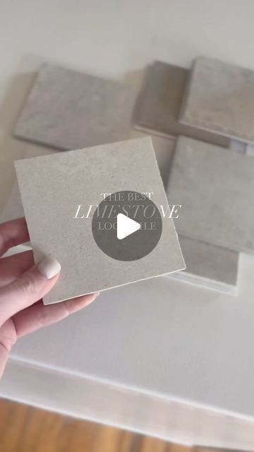 someone holding up a business card with the words little love on it in front of some other cards