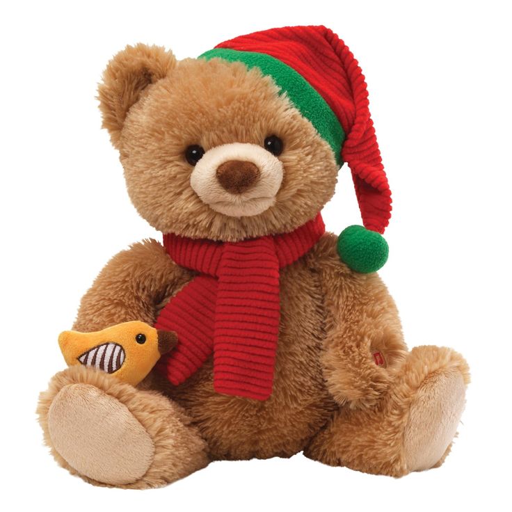 a brown teddy bear wearing a red and green hat with a fish on it's chest