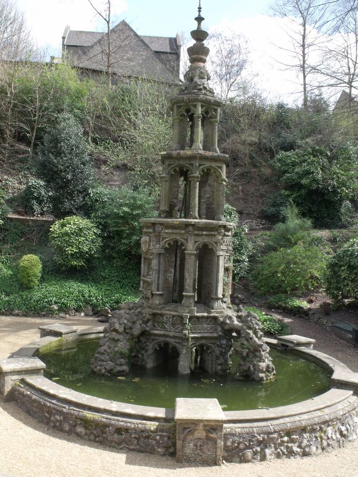 a water fountain in the middle of a garden