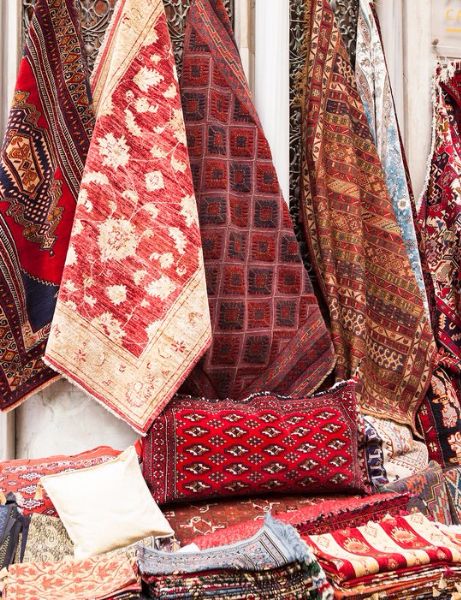 many different colored rugs and pillows on display