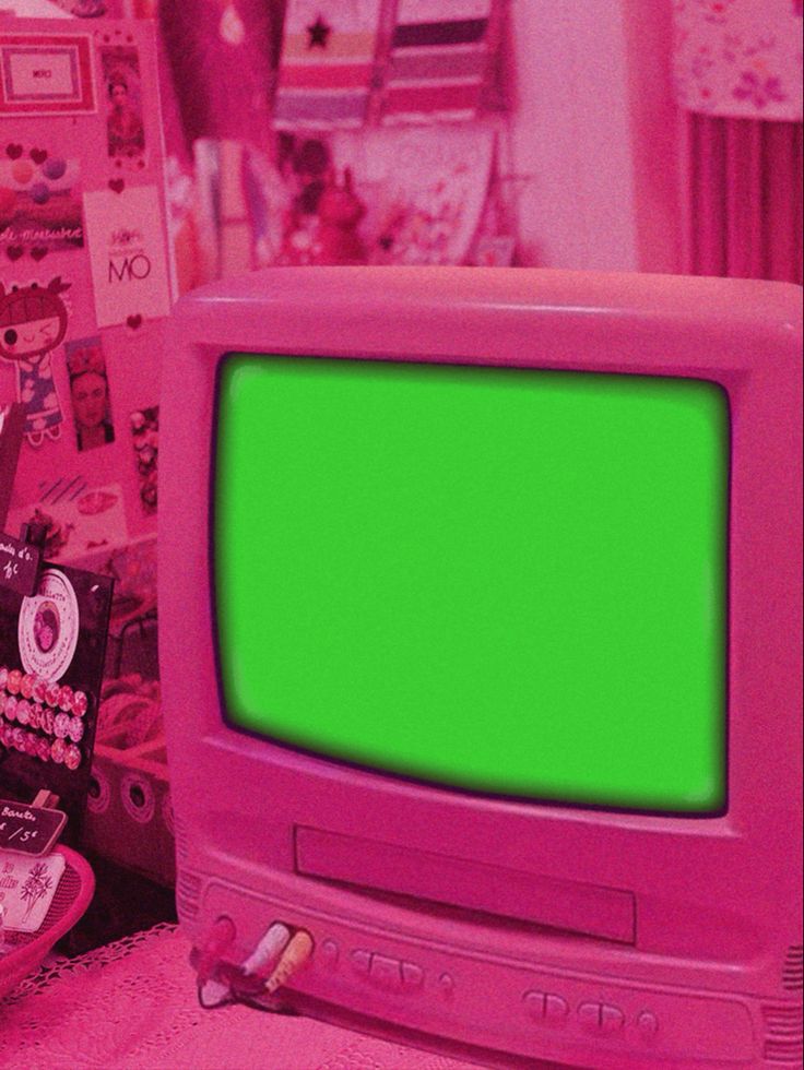 an old pink television with a green screen