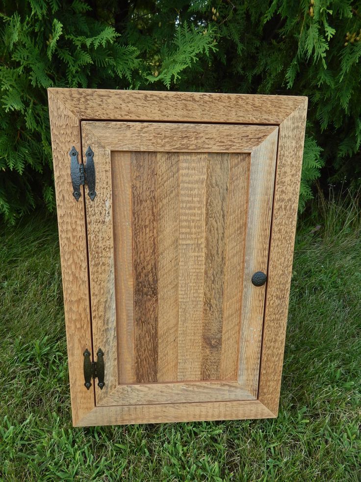 a small wooden cabinet sitting in the grass