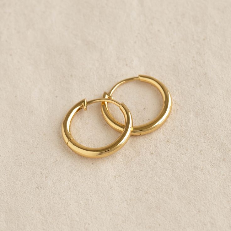 A classic pair of small hoop earrings, crafted in gold vermeil. 

An everyday essential that can be stacked with smaller huggie earrings or dainty studs.


Inner diameter: 13.8mm

Outer diameter: 18mm

Thickness: 2.5mm 

Hinge back closure Huggies Gold Earrings, Simple Gold Hoop Earrings, Puffy Heart Necklace, Small Gold Hoop Earrings, Small Gold Hoops, Mother Jewelry, London Blue Topaz Ring, Dainty Studs, Small Hoop Earrings